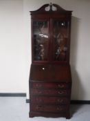 A reproduction mahogany bureau bookcase