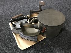 A tray of vintage irons, shoe last,