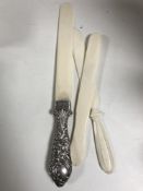 A silver handled ivory letter knife with crest,
