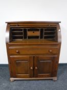 An oak roll top bureau