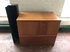 A low teak cabinet together with a black CD stand