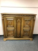 A continental carved oak sideboard