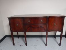A reproduction mahogany breakfronted sideboard