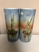 A pair of French ceramic vases depicting boats on still water