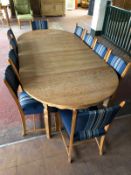 A light oak early 20th century extending table with two leaves and matching set of ten chairs