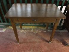 A continental oak side table fitted with a drawer