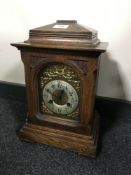 An oak cased bracket clock with brass dial