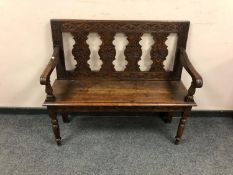 A 19th century carved oak settle