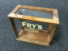 A vintage glass display cabinet with later 'Frys' advertising.