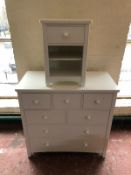 A contemporary seven drawer chest together with matching bedside stand