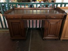 An early twentieth century oak pedestal desk