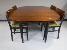 An early twentieth century dining room table together with four chairs