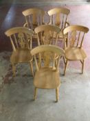 A pine farmhouse dining room table together with six chairs