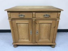 A 19th century pine side cabinet fitted two drawers