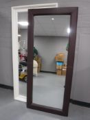 A painted framed overmantel mirror and a leather framed mirror