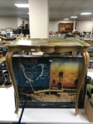 A wooden model of a ship in display case and a painted occasional table