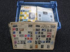 A basket containing eleven mid 20th century Trustey stamp albums and stamps