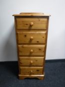 A contemporary pine five drawer chest