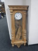 A continental oak cased wall clock
