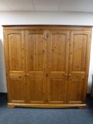 A contemporary pine four door wardrobe