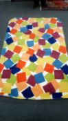 A contemporary hand tufted carpet with multi colour block design, 220 cm x 157 cm.