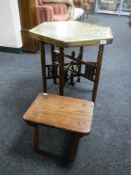 An Eastern octagonal folding brass top table and a rustic stool
