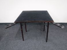 A folding card table with drinks slides