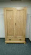 A late Victorian pine double wardrobe,