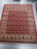 A Persian design rug on red ground