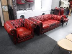 A three piece red button leather Chesterfield suite, comprising three seater settee,