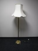 A brass column standard lamp and shade