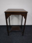 An Edwardian oak occasional table