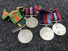 Four unnamed WWII medals with ribbons