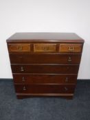 A contemporary five drawer chest and a drum table