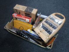 A box containing Black & Decker drill, router bit sets, screwdriver set,