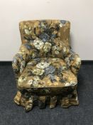 A mid 20th century armchair in button fabric