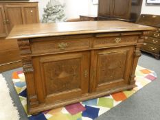 A continental carved oak sideboard, width 157 cm.