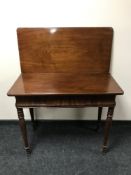 A 19th century foldover top tea table fitted a drawer