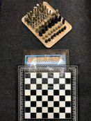 Two chess boards and three sets of chess pieces