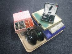 Two green glass decanters with pewter mounts and assorted cased cutlery