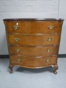 A walnut serpentine fronted four drawer chest