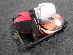 A crate containing twelve sports caps; The Portland Trailblazers, The Charlotte Hornets,