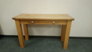 A contemporary light oak single drawer hall table,