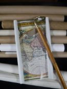 A brass headed walking stick and a quantity of rolled maps, prints,