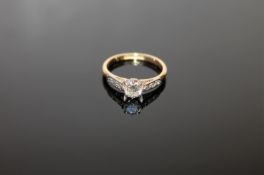 An 18ct gold solitaire diamond ring, approximately 0.5ct, size J, set with diamond shoulders.