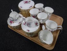 A tray of fifty-seven pieces of Royal Victoria Summer Rose tea china and two china milk jugs