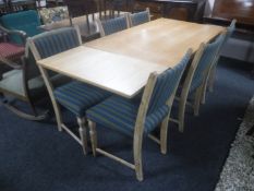 A blonde oak pull out table and six chairs