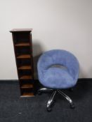 A contemporary swivel desk chair and a stained pine CD stand