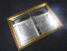 A gilt framed etched mirror depicting a gypsy caravan