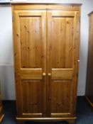 A contemporary pine double door wardrobe